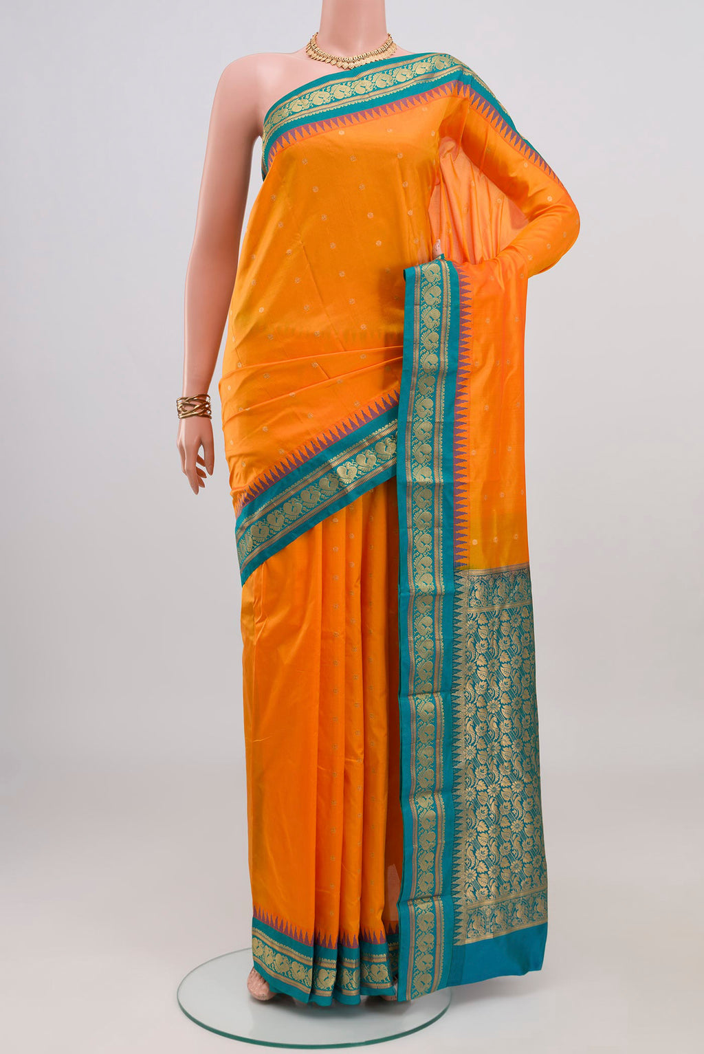 Orange Blended Bangalore Silk Saree with Zari Butta on the body and Zari Border.  displayed on a mannequin