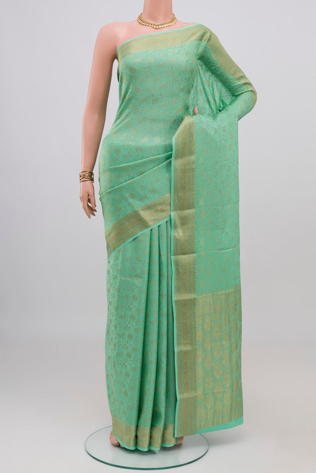 Sea Green Mysore Crepe Saree with Zari Brocade on the body and Zari Border.  displayed on a mannequin
