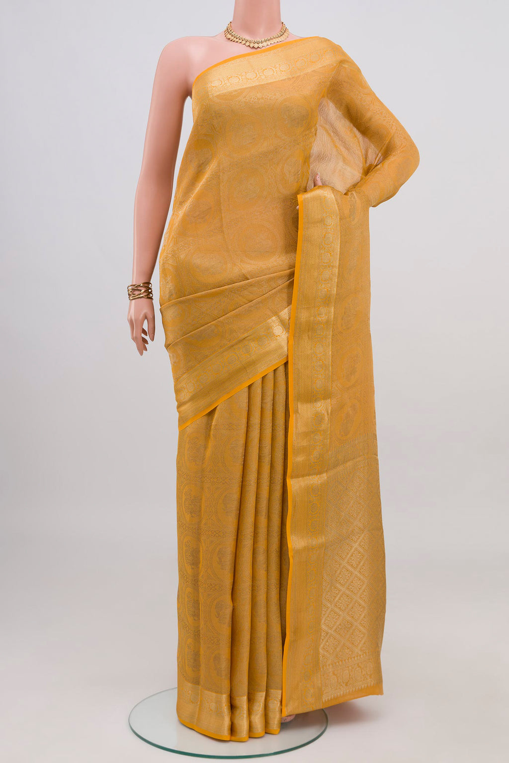 Yellow Mysore Crepe Saree with Zari Brocade on the body and Zari Border.  displayed on a mannequin