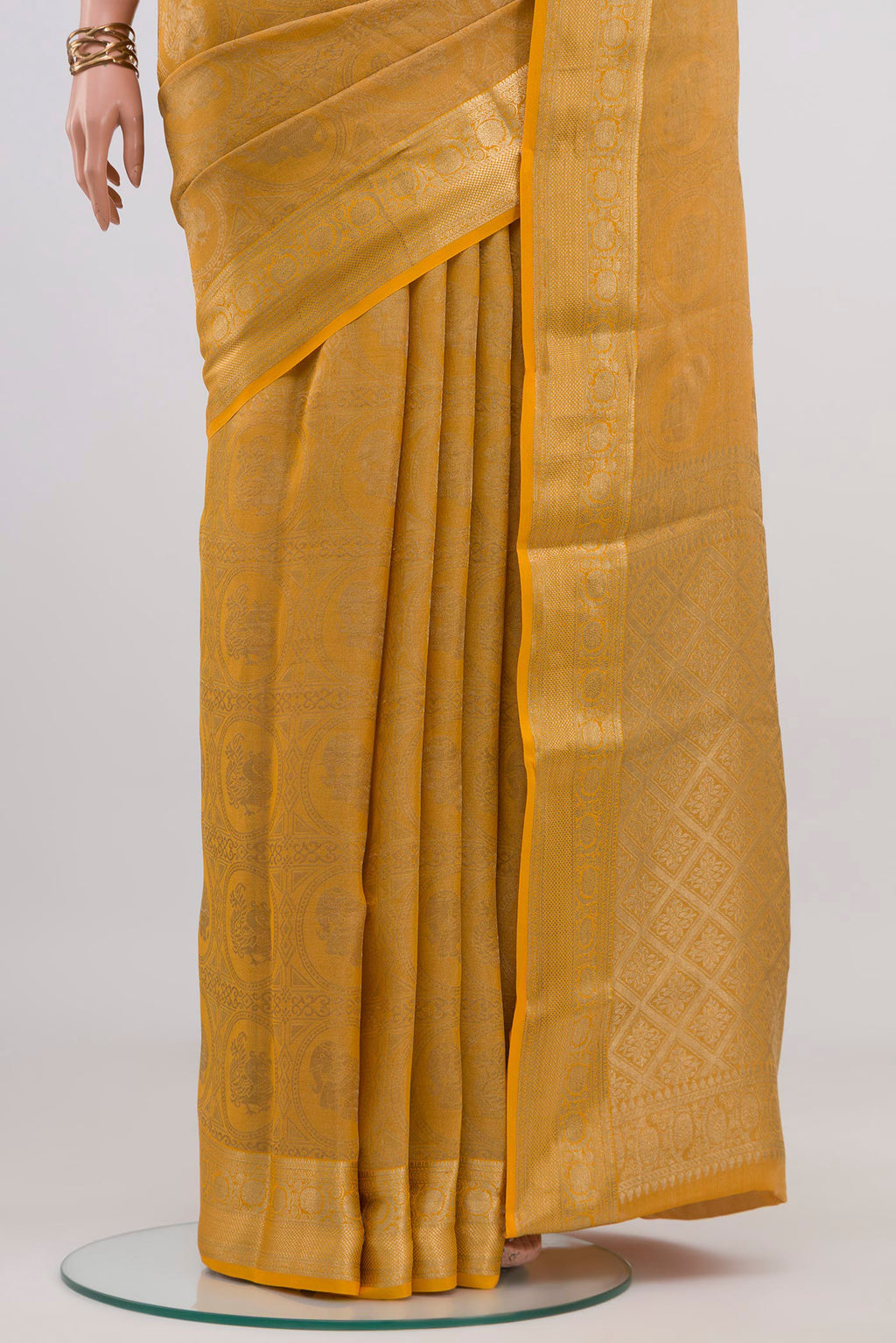Pleats and pallu of Yellow Mysore Crepe Saree with Zari Brocade on the body and Zari Border. 