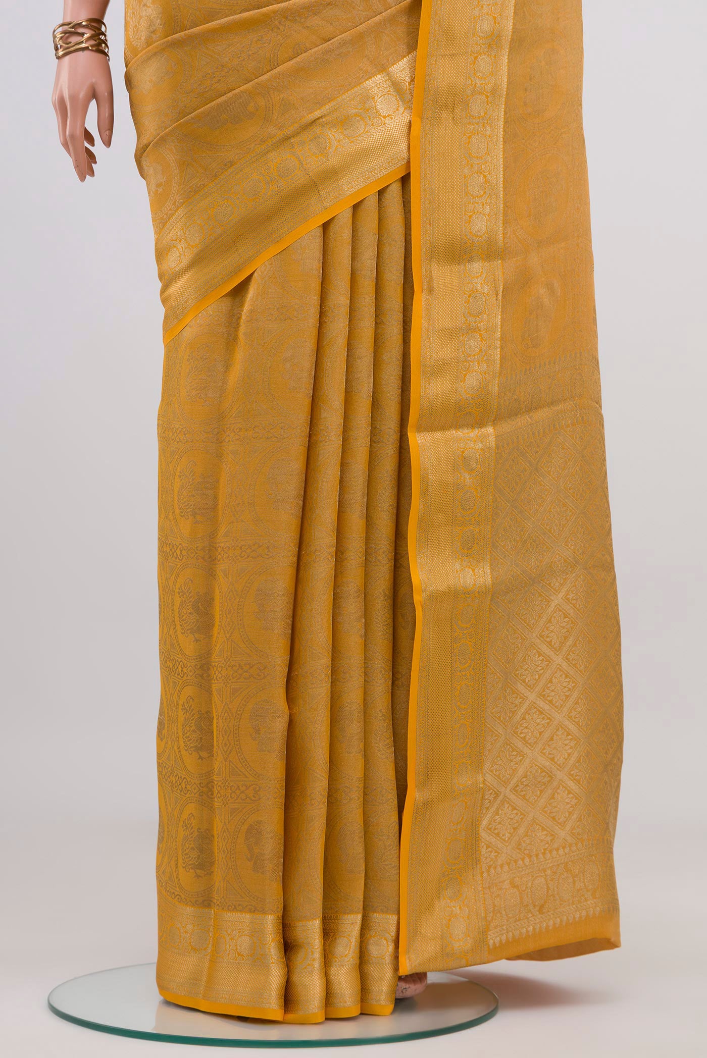 Pleats and pallu of Yellow Mysore Crepe Saree with Zari Brocade on the body and Zari Border. 