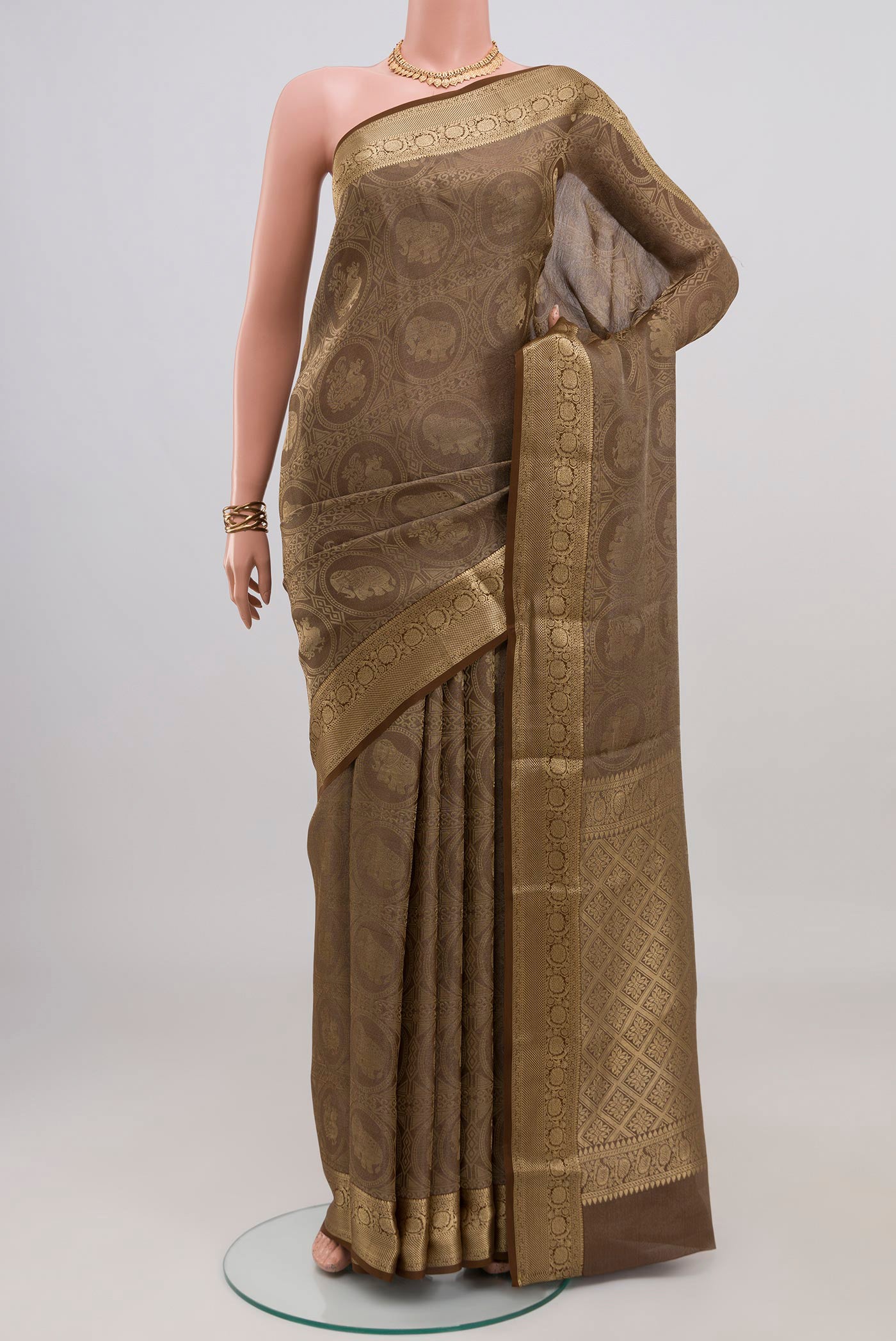 Brown Mysore Crepe Saree with Zari Brocade on the body and Zari Border.  displayed on a mannequin