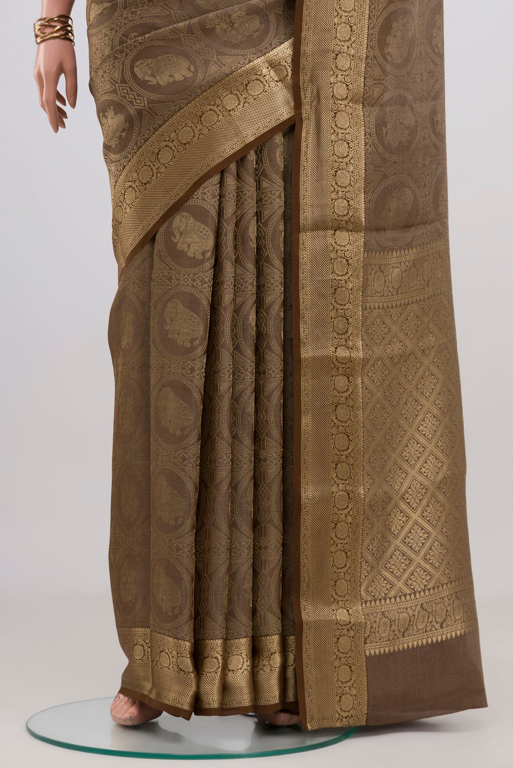 Pleats and pallu of Brown Mysore Crepe Saree with Zari Brocade on the body and Zari Border. 