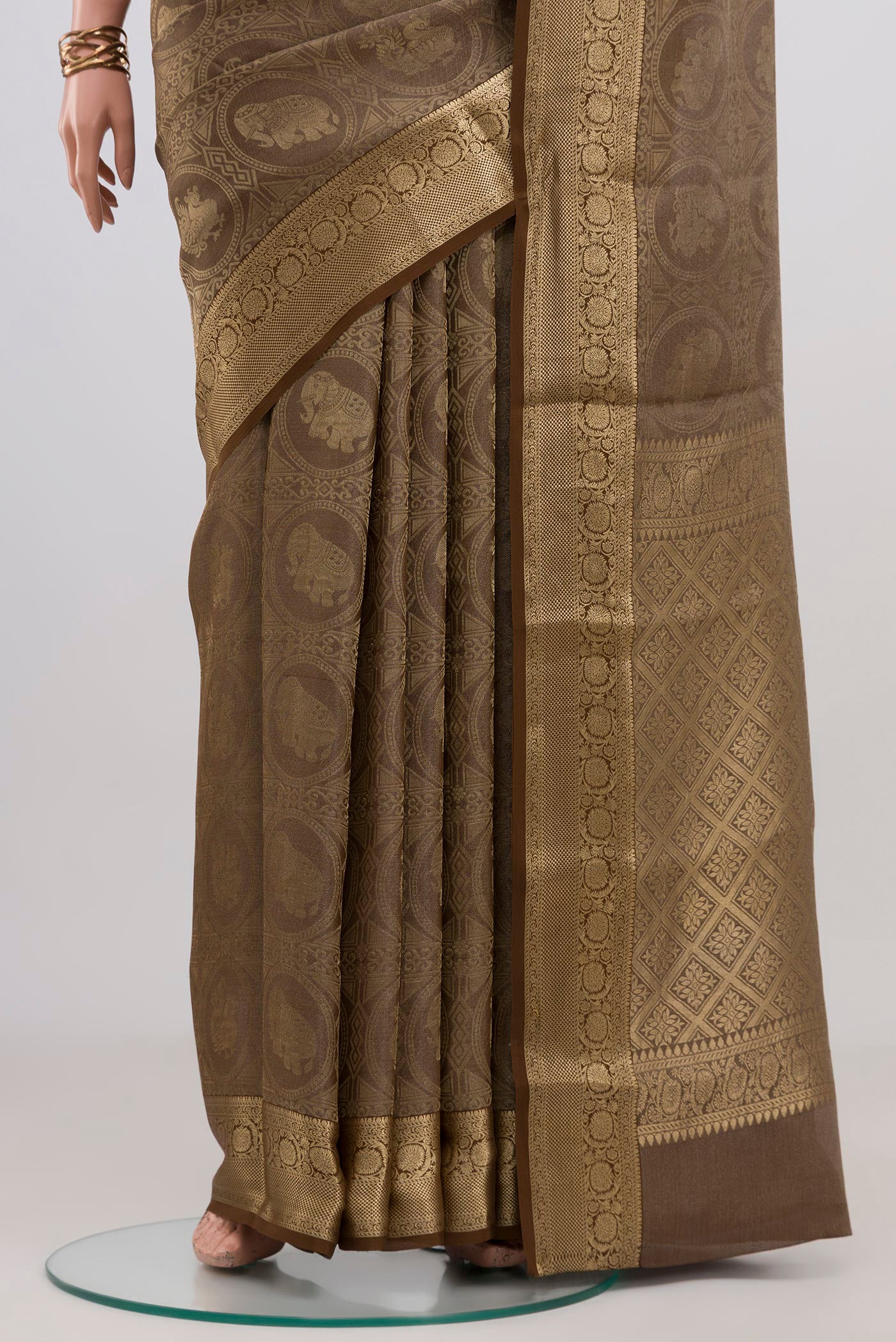 Pleats and pallu of Brown Mysore Crepe Saree with Zari Brocade on the body and Zari Border. 