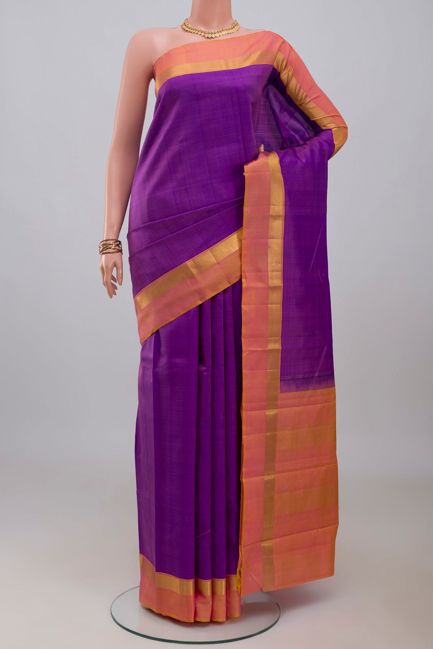 Purple Kanjivaram Silk Saree with Plain Body and Zari Border.  displayed on a mannequin