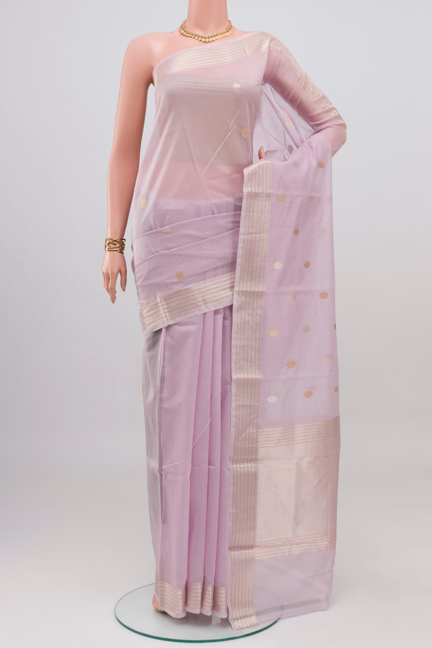Lavender Kora Cotton Saree with Zari Butta on the body and Thin Zari Line.  displayed on a mannequin