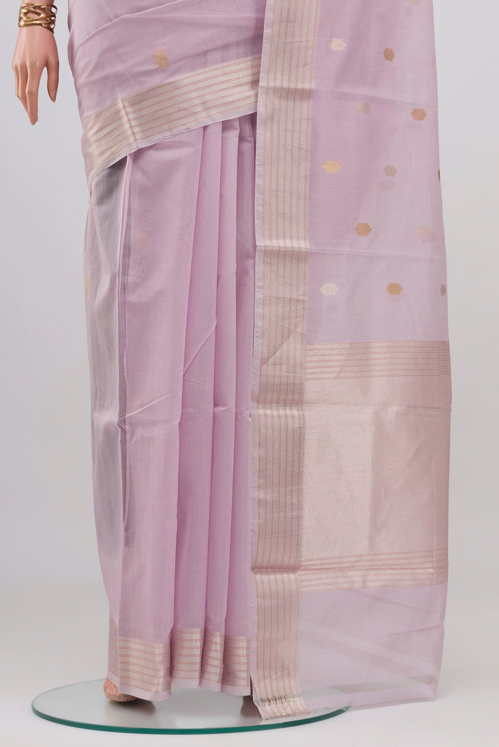 Pleats and pallu of Lavender Kora Cotton Saree with Zari Butta on the body and Thin Zari Line. 