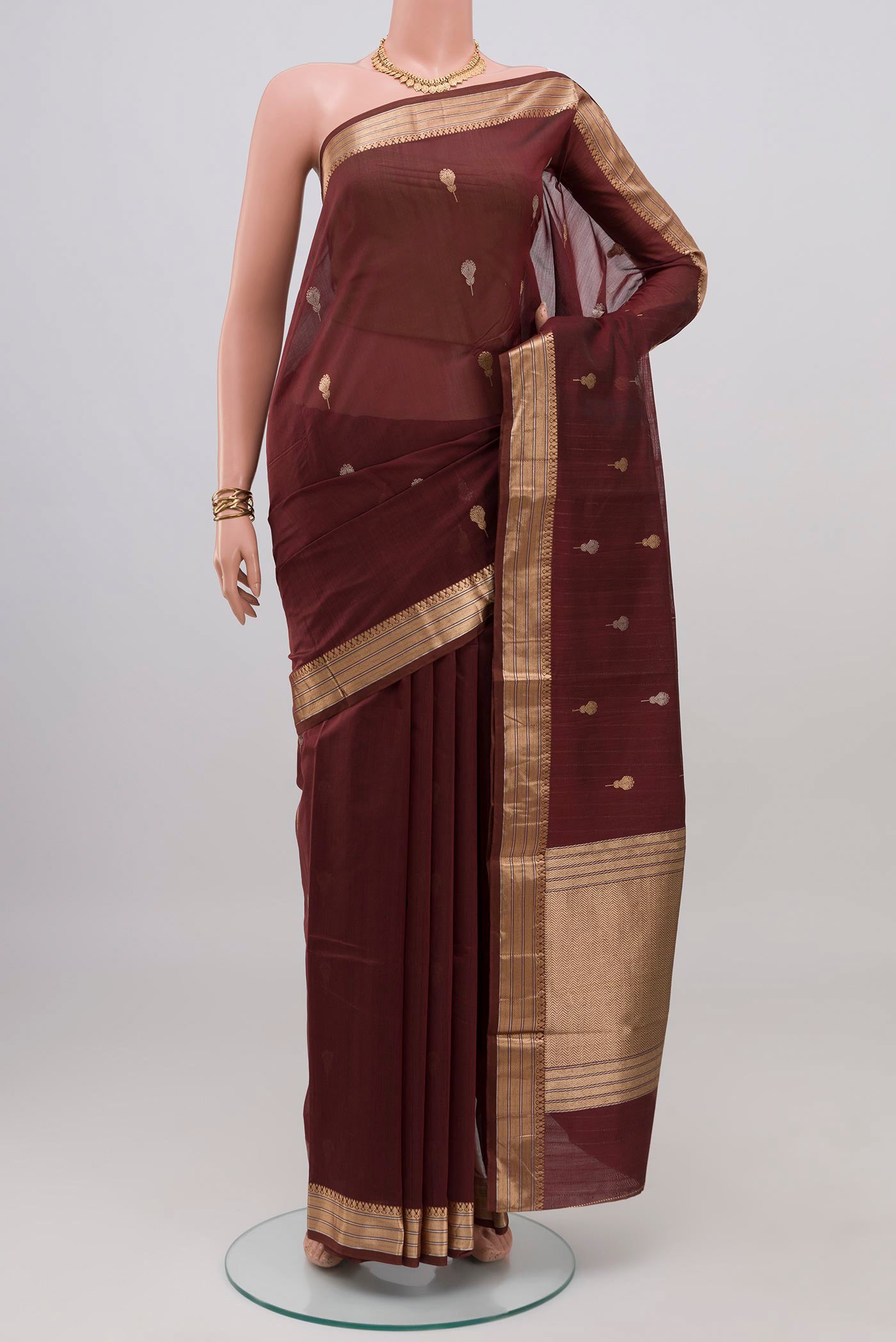 Coffee Brown Banarasi Kora Cotton Saree with Zari Butta on the body and Zari Border.  displayed on a mannequin