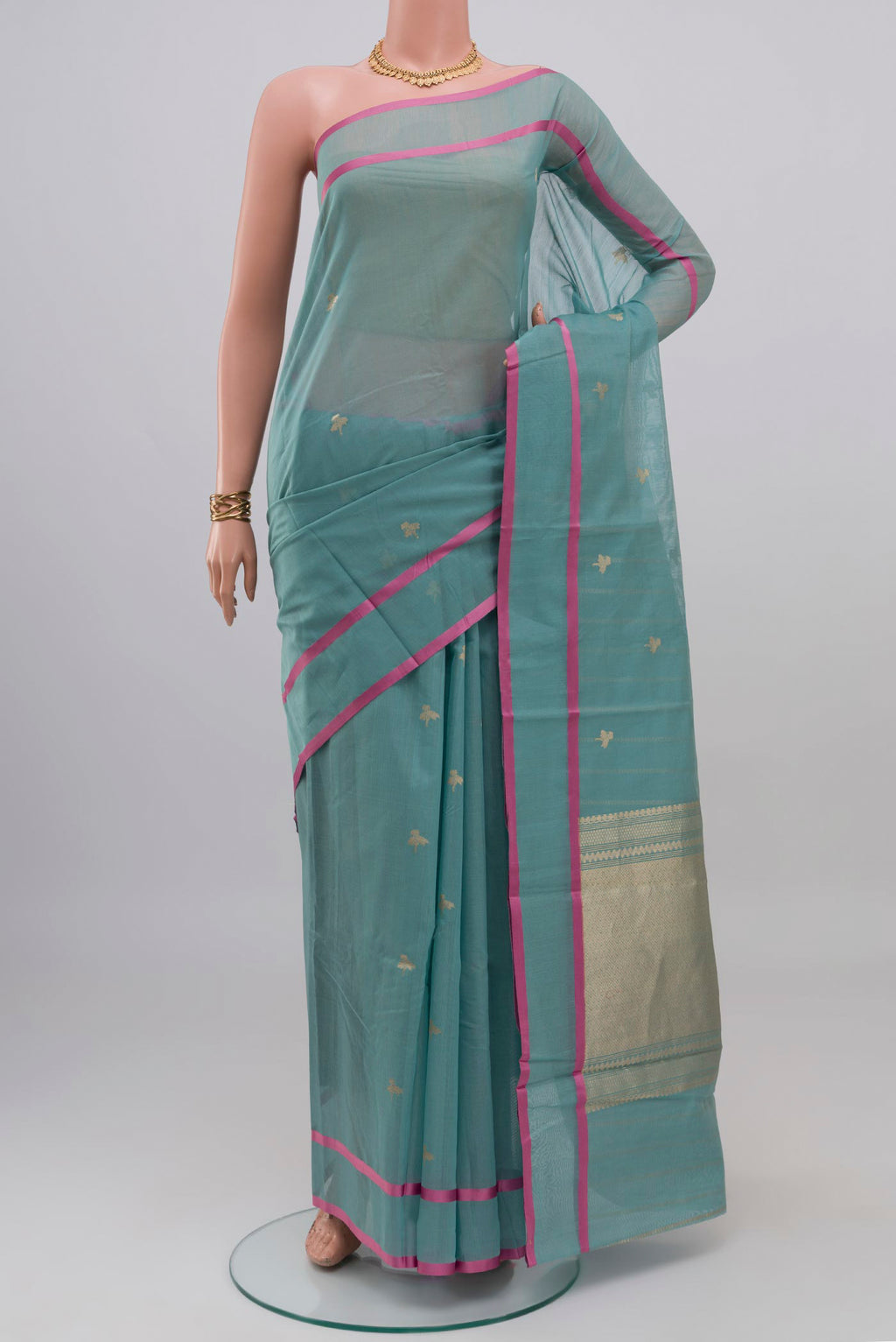 Blue Kora Cotton Saree with Zari Butta on the body and Thin Zari Line.  displayed on a mannequin