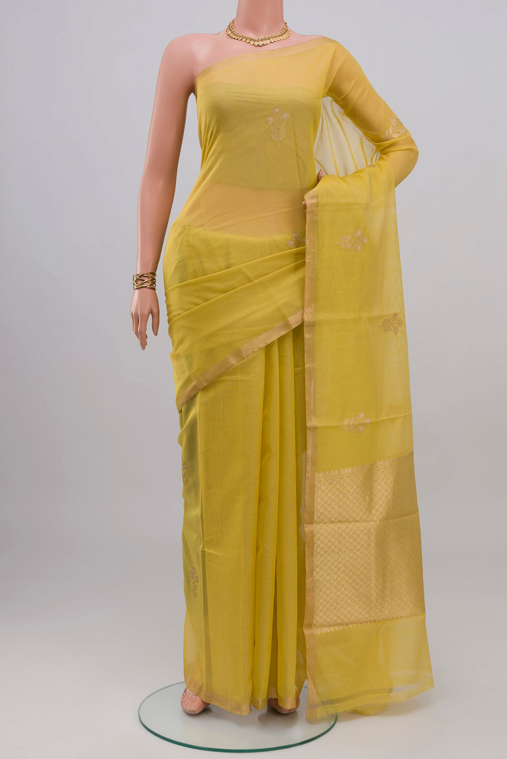 Lemon Yellow Kora Cotton Saree with Zari Butta on the body and Thin Zari Line.  displayed on a mannequin