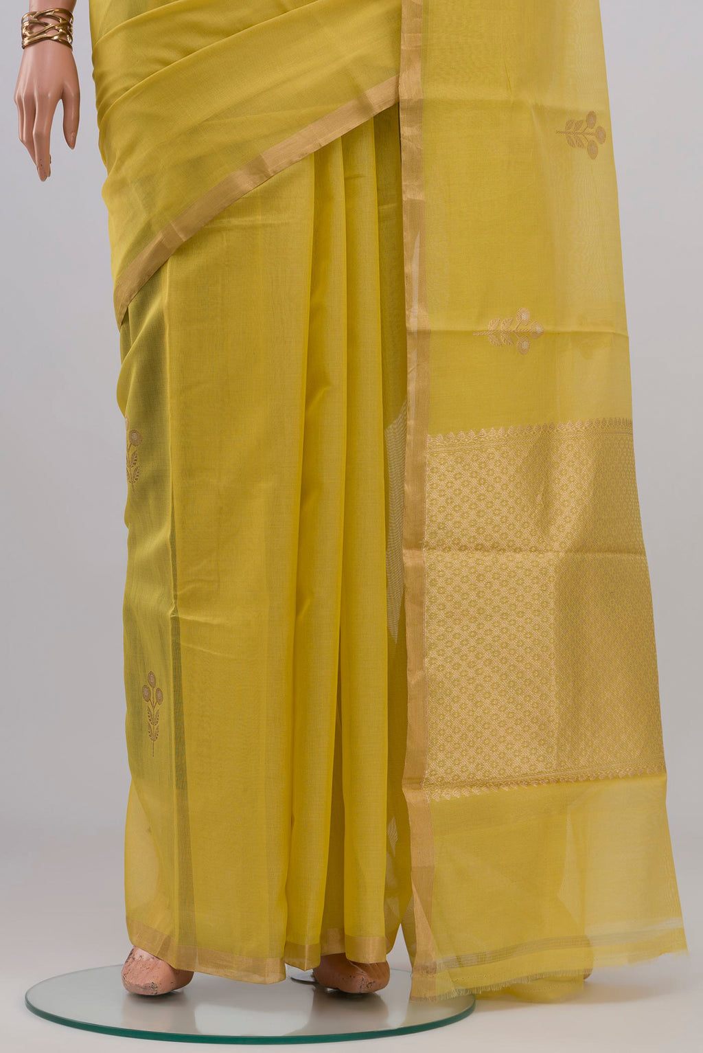 Pleats and pallu of Lemon Yellow Kora Cotton Saree with Zari Butta on the body and Thin Zari Line. 