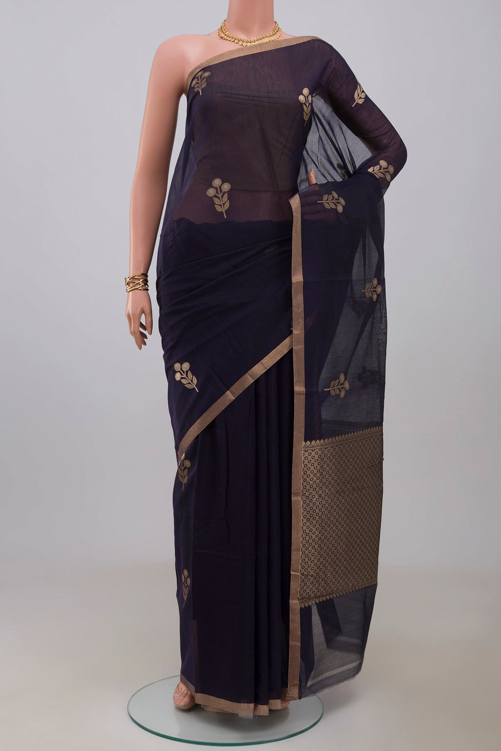 Navy Blue Banarasi Kora Cotton Saree with Zari Butta on the body and Zari Border.  displayed on a mannequin