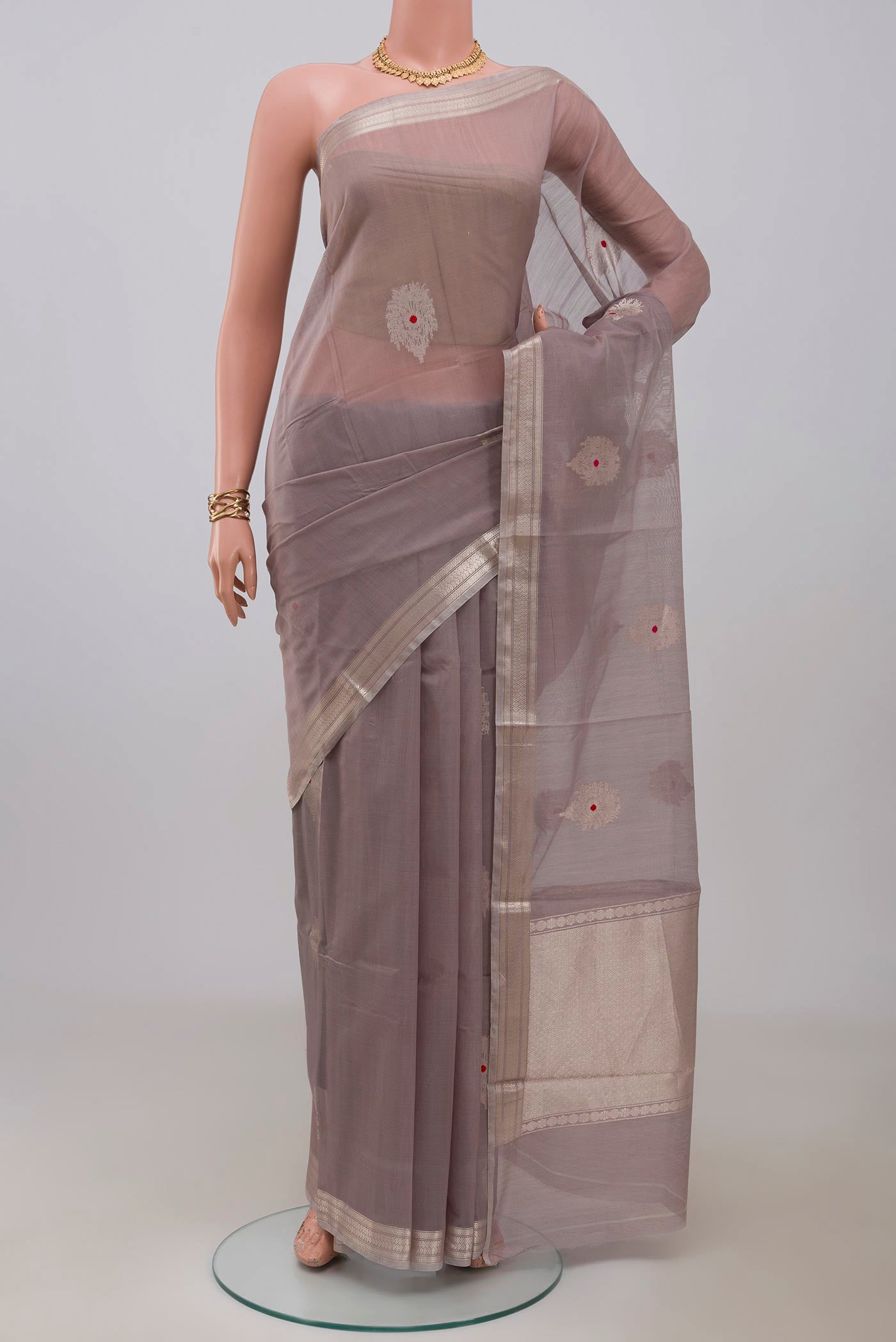 Grey Banarasi Kora Cotton Saree with Zari Butta on the body and Zari Border.  displayed on a mannequin