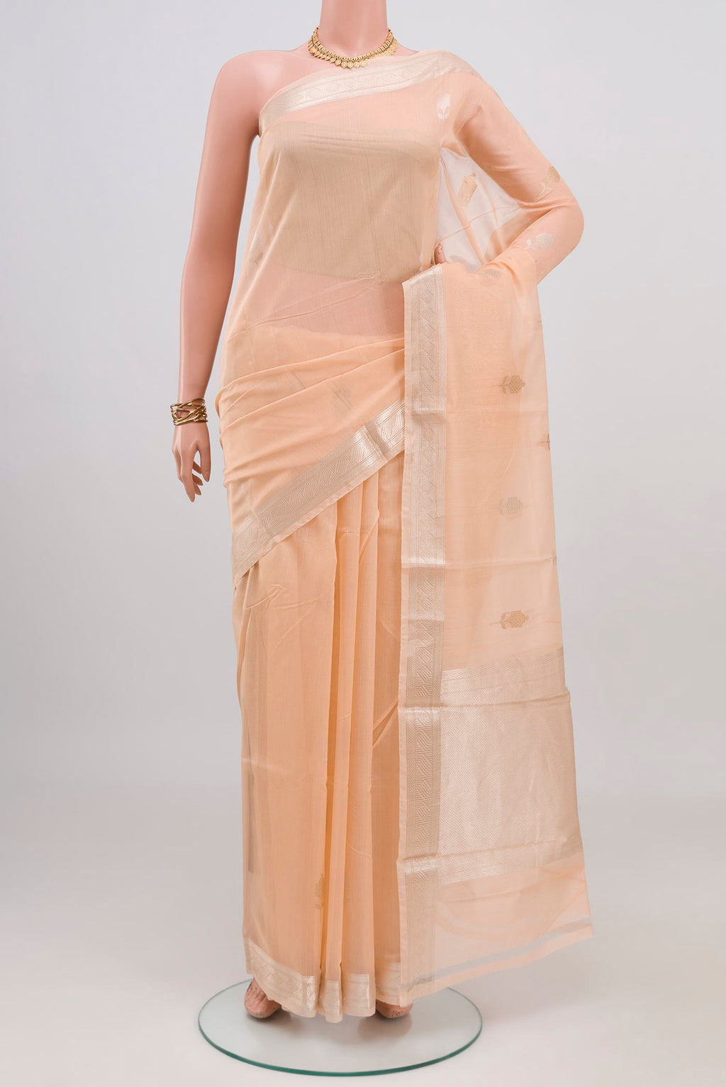 Peach Chanderi Silk Cotton Saree with Zari Butta on the body and Zari Border.  displayed on a mannequin