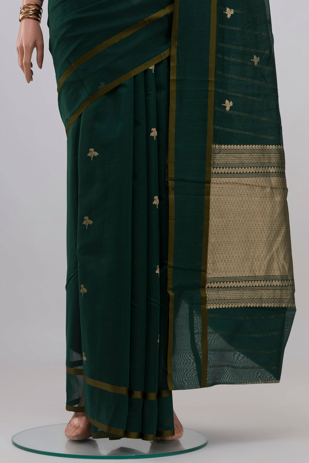 Pleats and pallu of Bottle Green Kora Cotton Saree with Zari Butta on the body and Thin Zari Line. 
