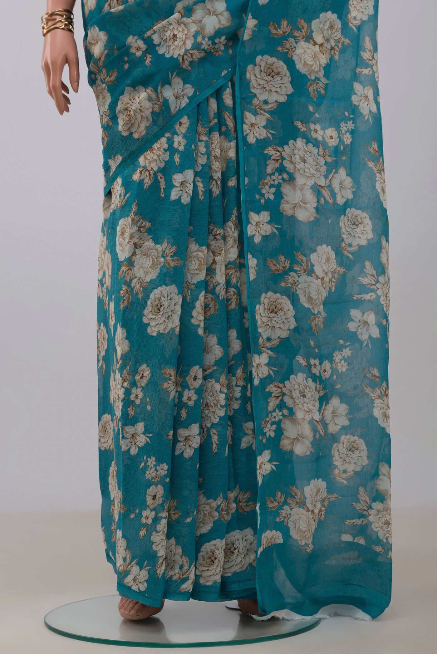 Pleats and pallu of Blue Chiffon Saree with Printed design on the body and Without Border. 