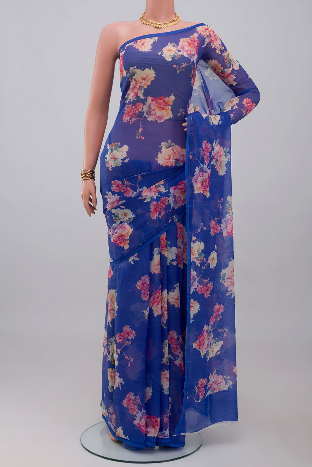 Royal Blue Chiffon Saree with Floral Print on the body and Without Border.  displayed on a mannequin