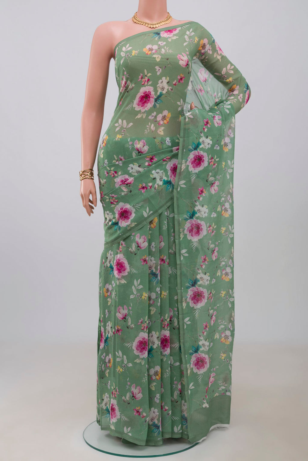 Green Chiffon Saree with Printed design on the body and Without Border.  displayed on a mannequin