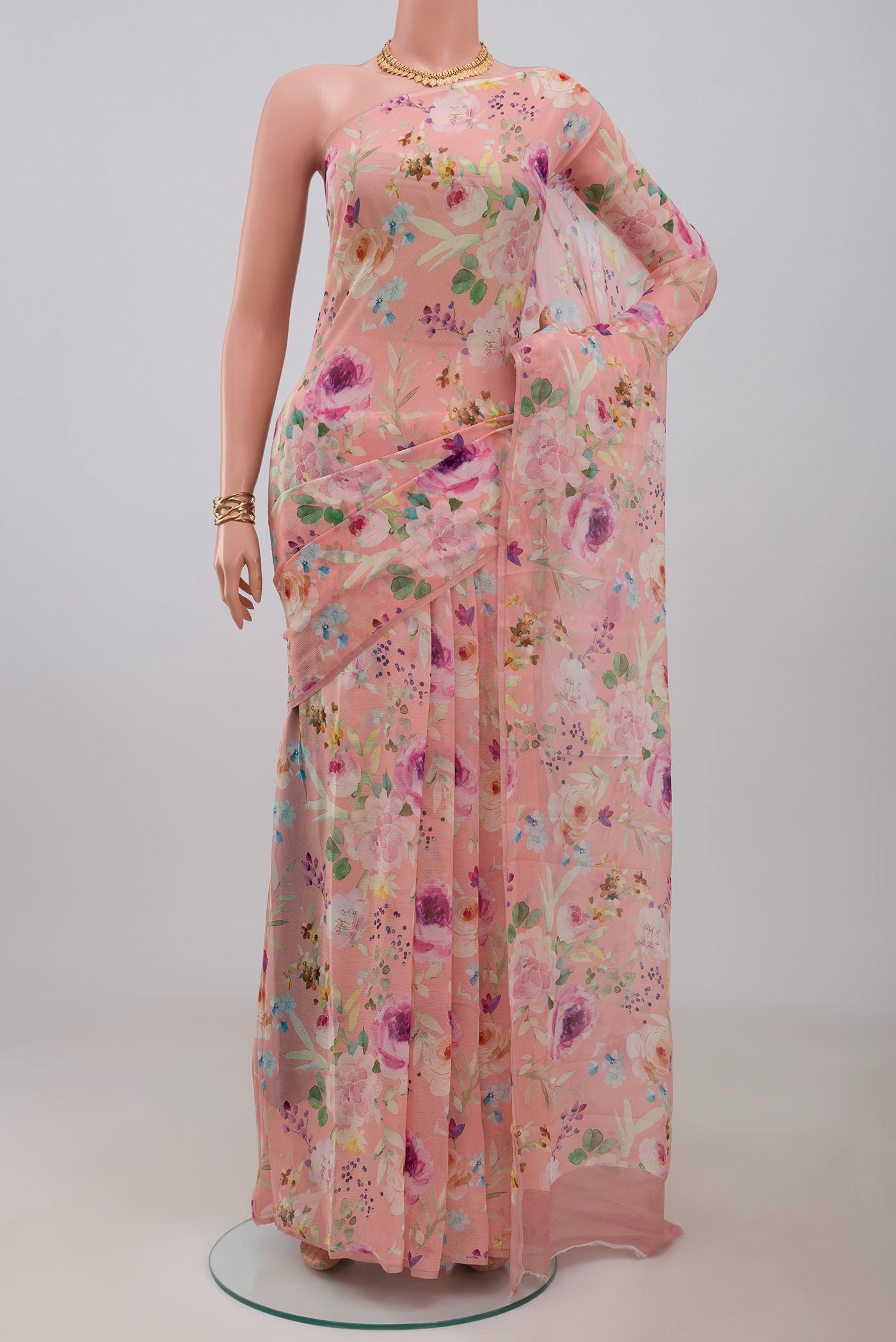 Peach Chiffon Saree with Printed design on the body and Without Border.  displayed on a mannequin