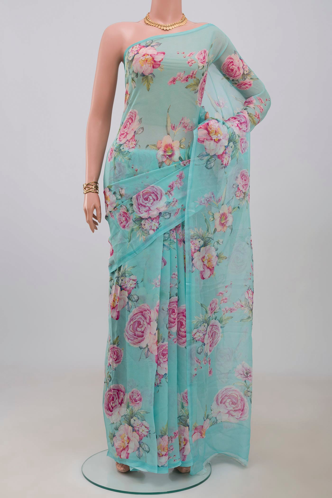 Blue Chiffon Saree with Printed design on the body and Without Border.  displayed on a mannequin
