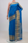 Pure Silk Blue Kanjivaram Saree with Zari Butta on the body and Zari Border.  displayed on a mannequin