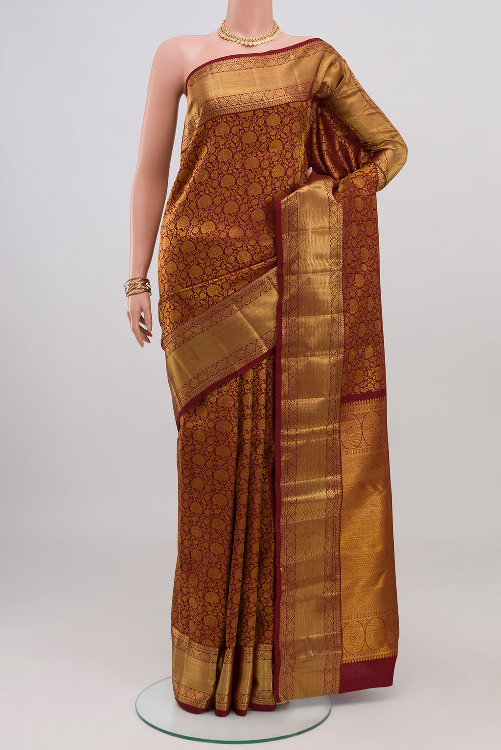 Maroon Kanchipuram Silk Saree with Zari Brocade on the body and Zari Border.  displayed on a mannequin