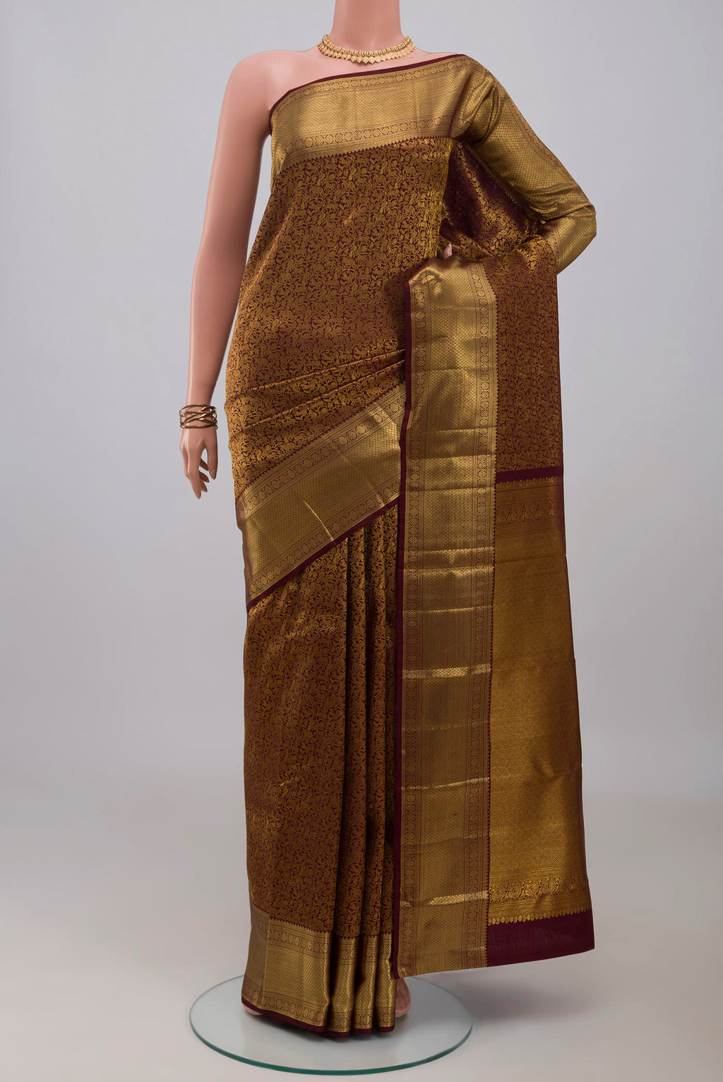 Brown Kanchipuram Silk Saree with Zari Brocade on the body and Zari Border.  displayed on a mannequin
