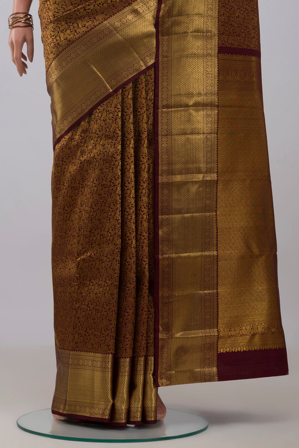 Pleats and pallu of Brown Kanchipuram Silk Saree with Zari Brocade on the body and Zari Border. 
