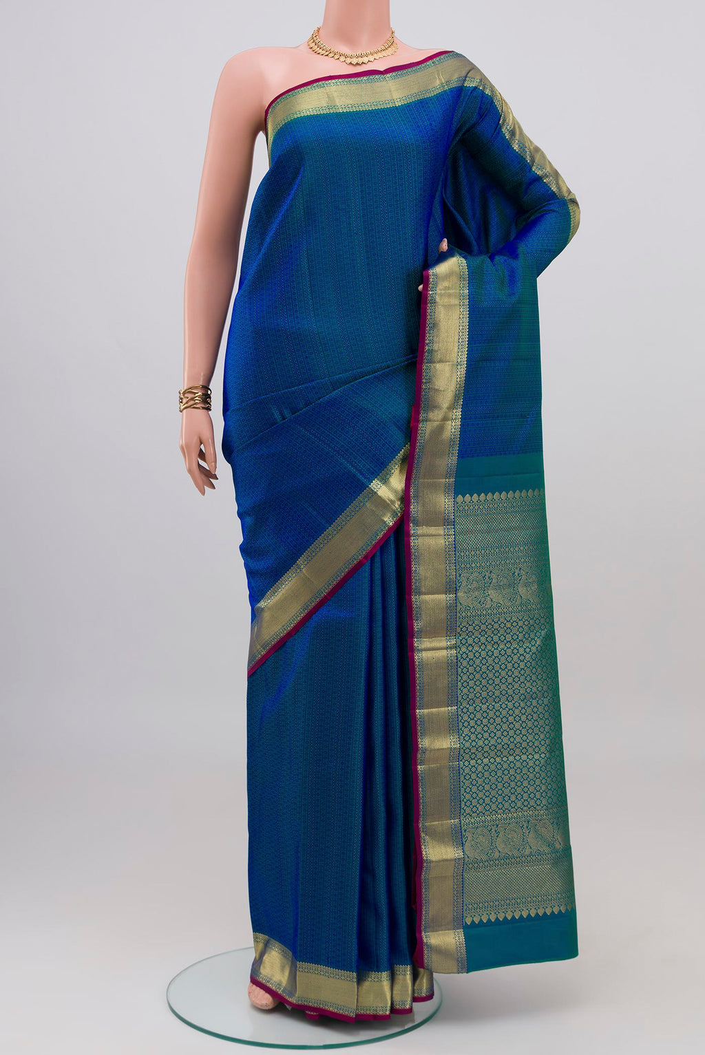 Peacock Blue Kanjivaram Silk Saree with Jacquard design on the body and Zari Border.  displayed on a mannequin