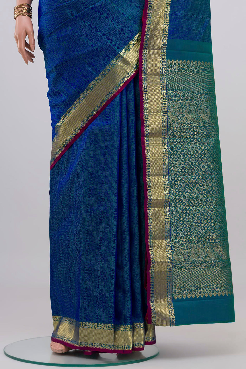 Pleats and pallu of Peacock Blue Kanjivaram Silk Saree with Jacquard design on the body and Zari Border. 