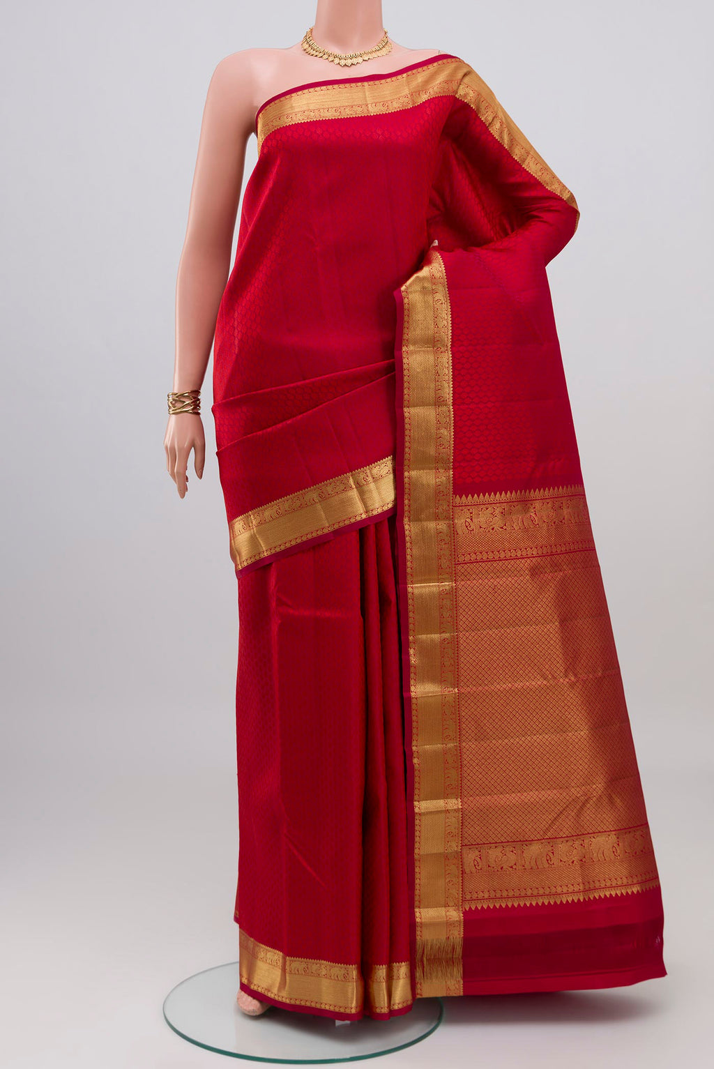 Red Kanjivaram Silk Saree with Jacquard design on the body and Zari Border.  displayed on a mannequin