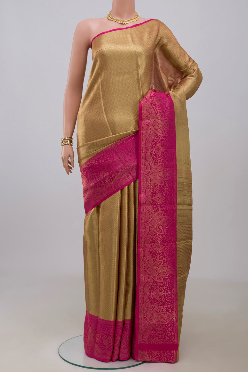 Golden Kanchipuram Silk Saree with Zari Brocade on the body and Fancy Border.  displayed on a mannequin