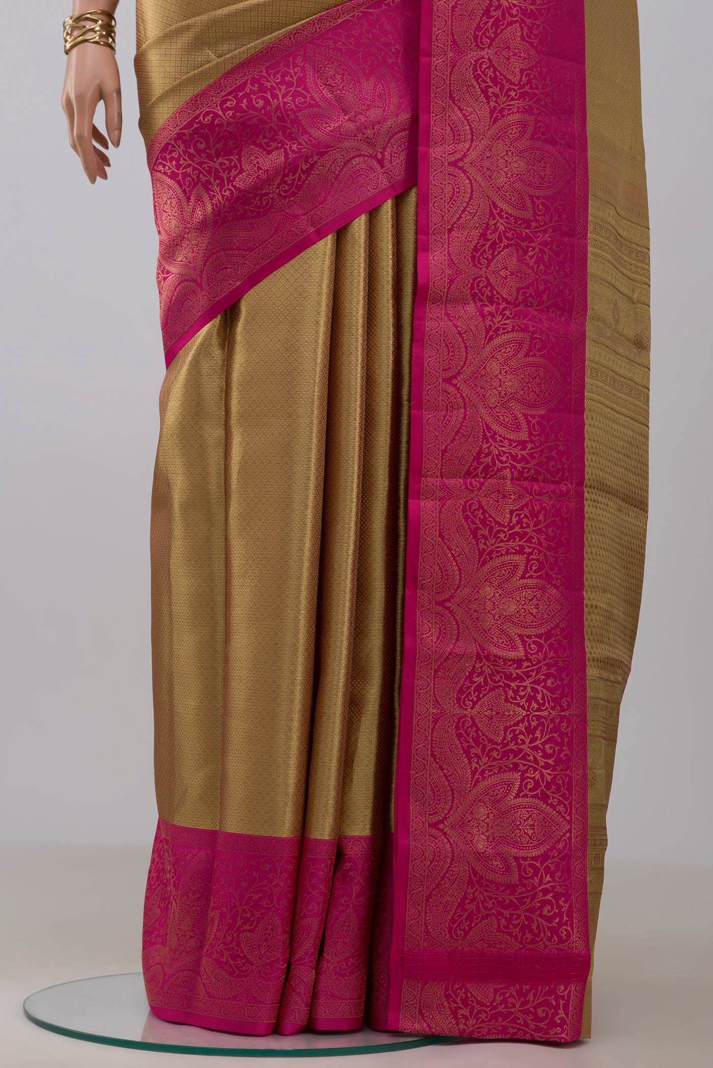 Pleats and pallu of Golden Kanchipuram Silk Saree with Zari Brocade on the body and Fancy Border. 