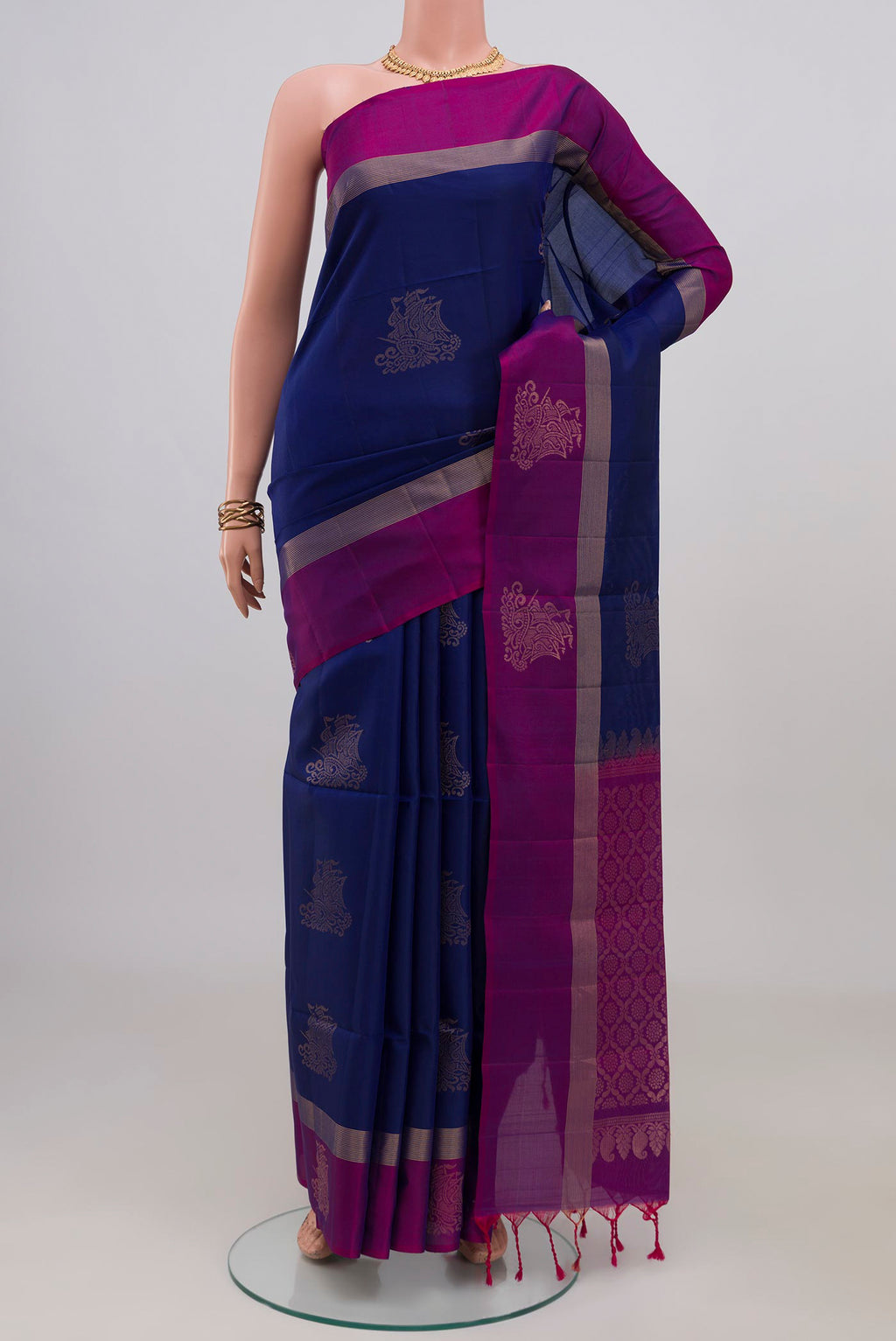 Blue Soft Silk Saree with Zari Butta on the body and Thin Zari Line.  displayed on a mannequin