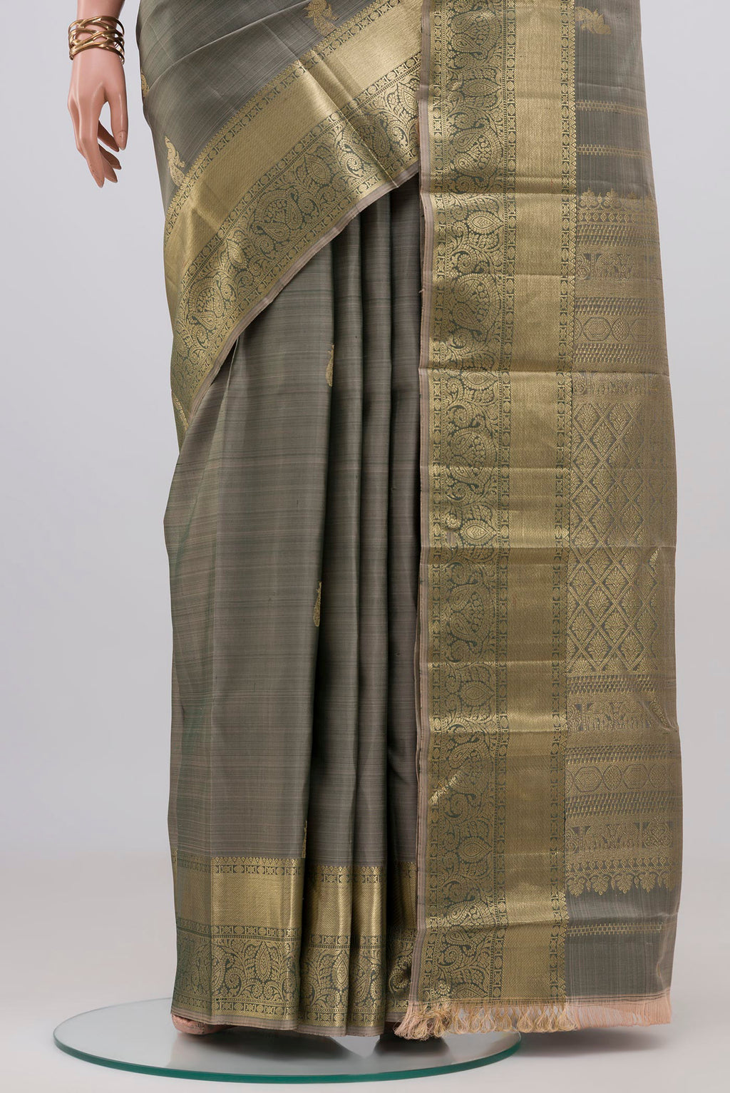Pleats and pallu of Grey Kanchipuram Silk Saree with Zari Butta on the body and Zari Border. 