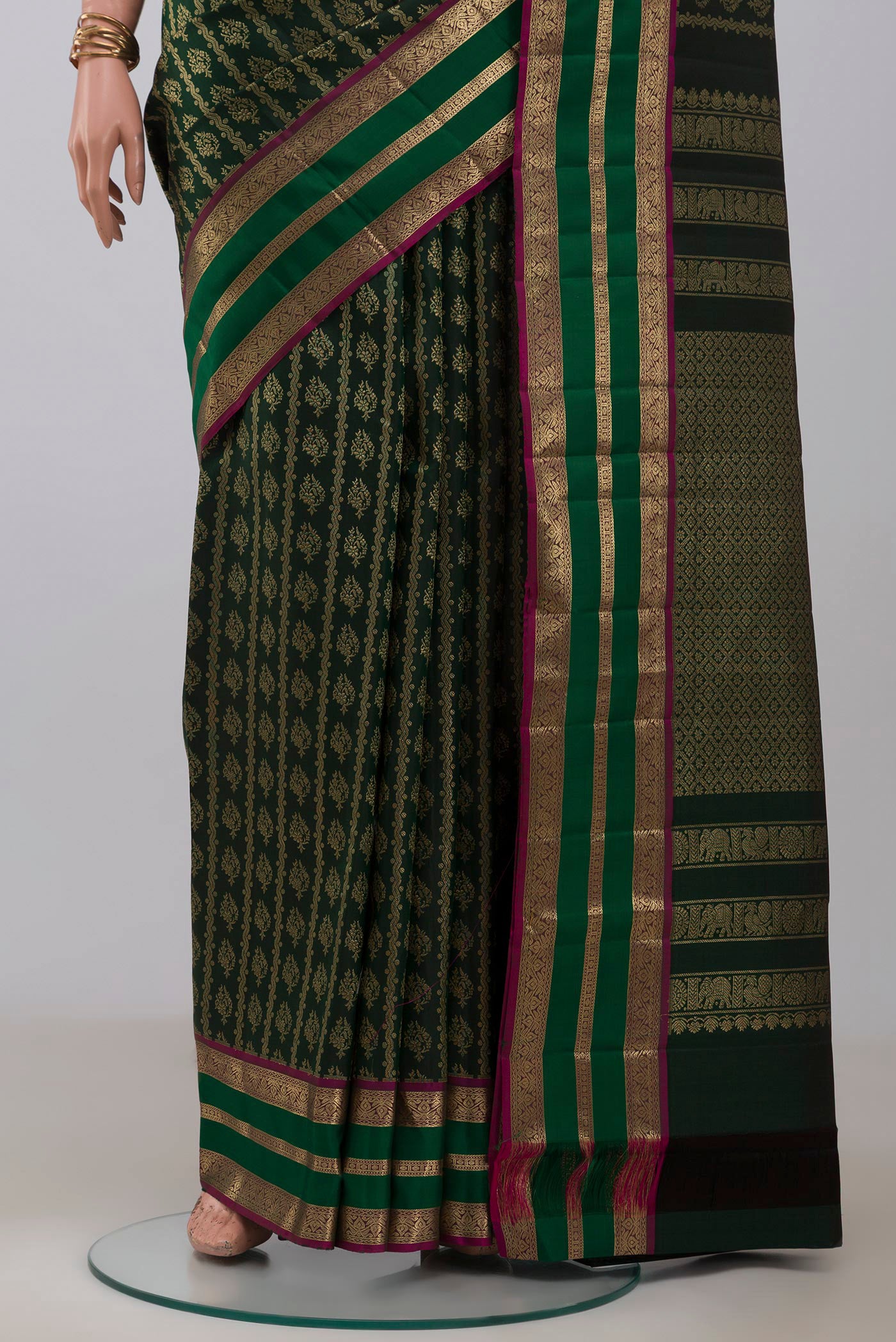 Pleats and pallu of Bottle Green Kanjivaram Silk Saree with Zari Brocade on the body and Zari Border. 