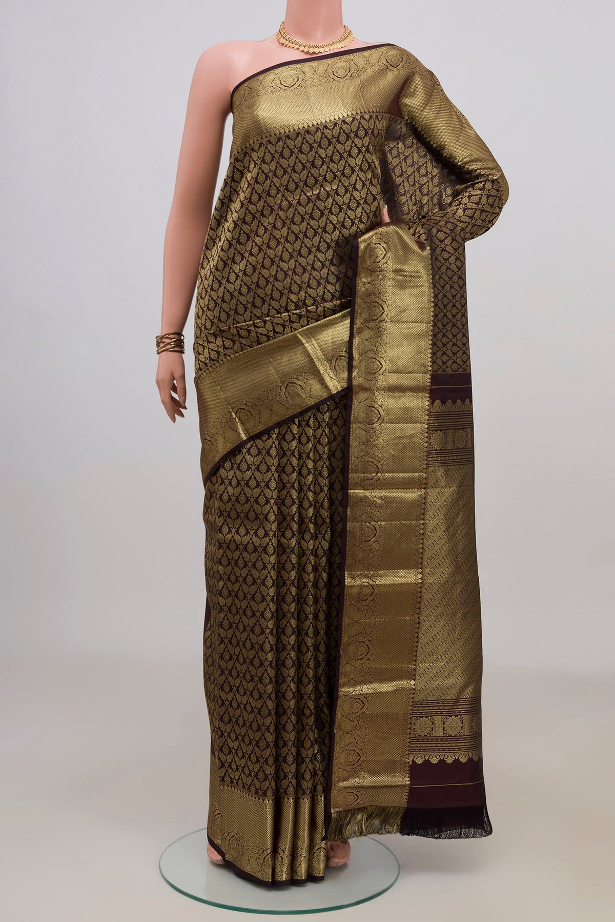 Pure Silk Coffee Brown Kanjivaram Saree with Zari Brocade on the body and Zari Border.  displayed on a mannequin