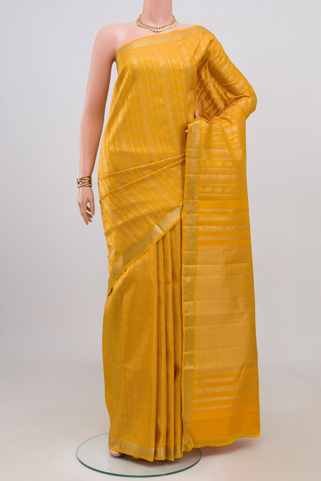 Yellow Kanjivaram Silk Saree with Zari Brocade on the body and Zari Border.  displayed on a mannequin
