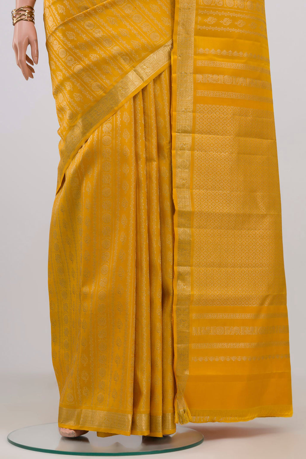 Pleats and pallu of Yellow Kanjivaram Silk Saree with Zari Brocade on the body and Zari Border. 