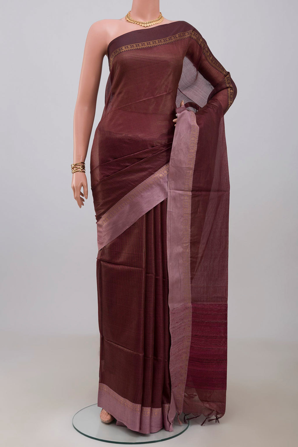 Brown Tussar Silk Saree with Stripes on the body and Plain Border.  displayed on a mannequin