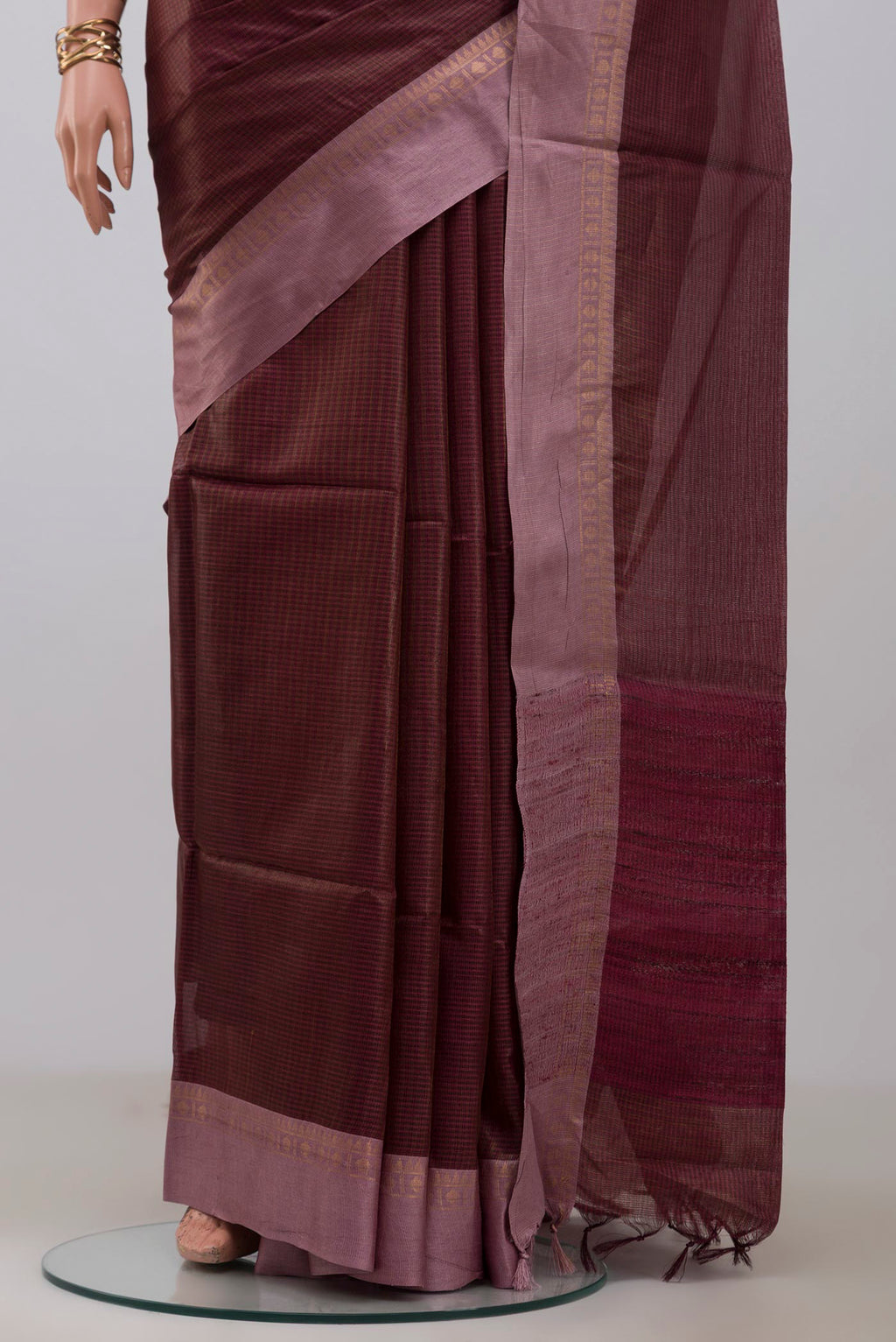 Pleats and pallu of Brown Tussar Silk Saree with Stripes on the body and Plain Border. 