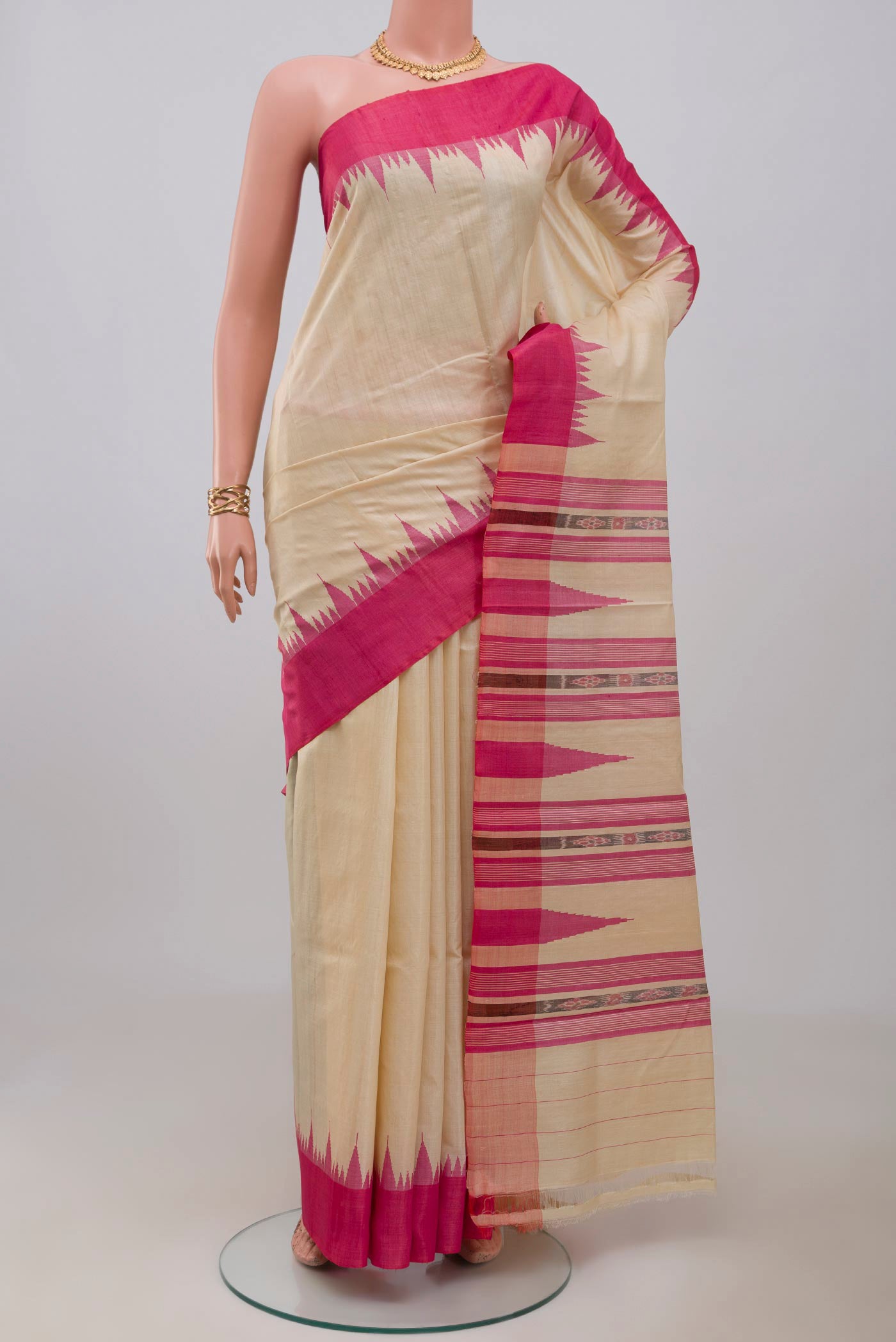 Cream Tussar Silk Saree with Plain Body and Temple Border.  displayed on a mannequin