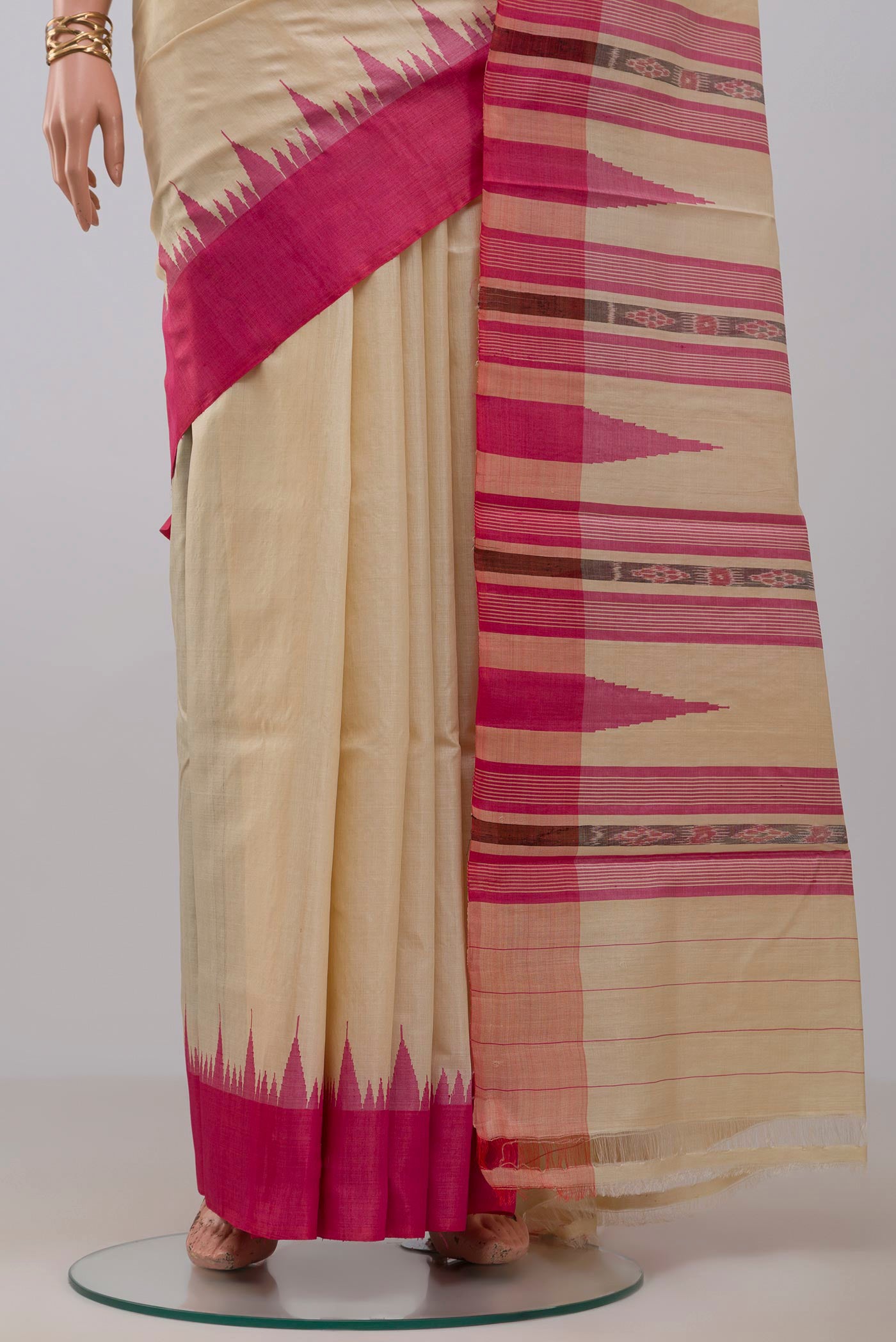 Pleats and pallu of Cream Tussar Silk Saree with Plain Body and Temple Border. 