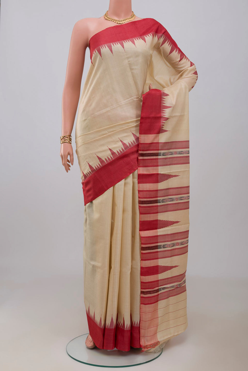 Cream Tussar Silk Saree with Plain Body and Temple Border.  displayed on a mannequin