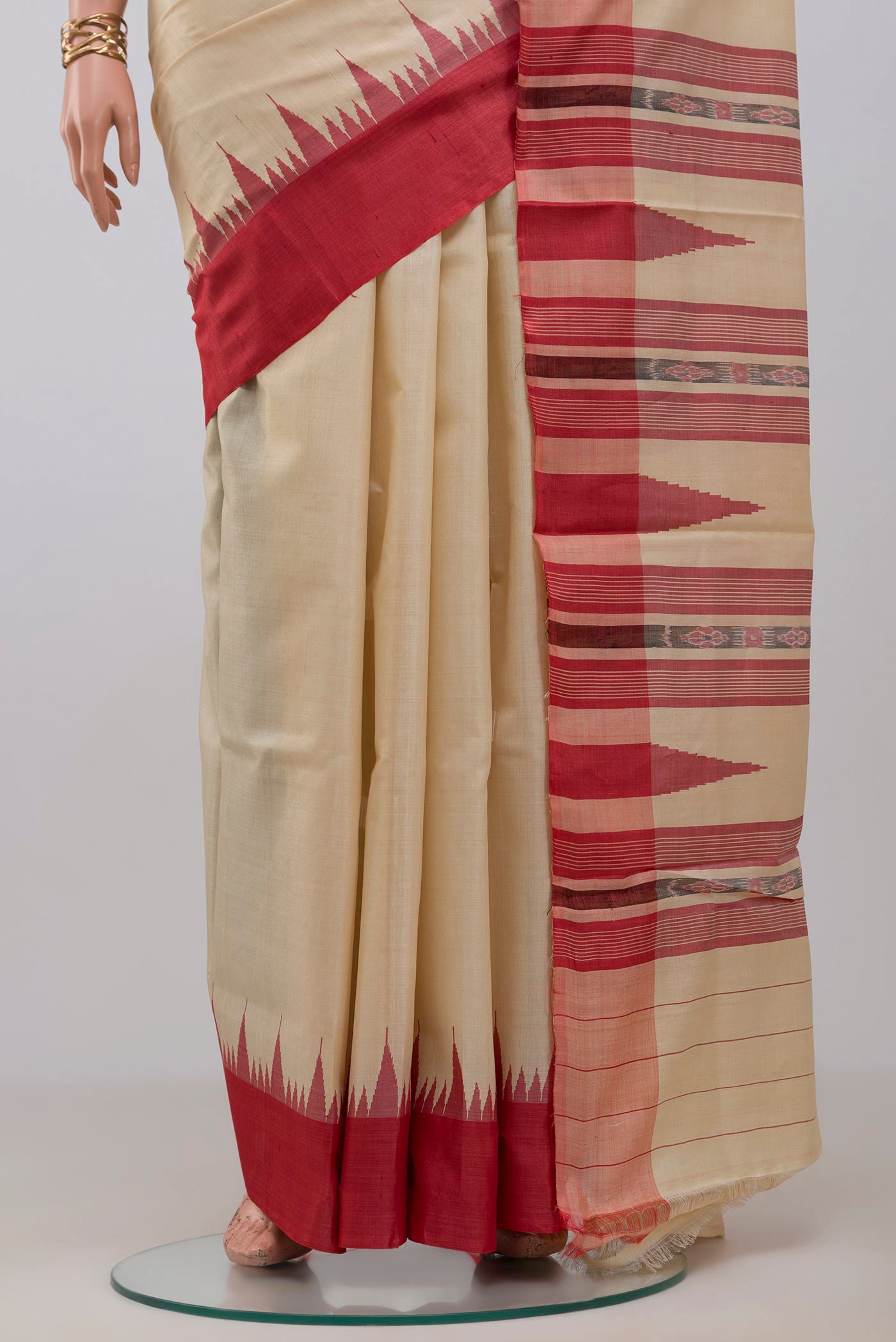 Pleats and pallu of Cream Tussar Silk Saree with Plain Body and Temple Border. 