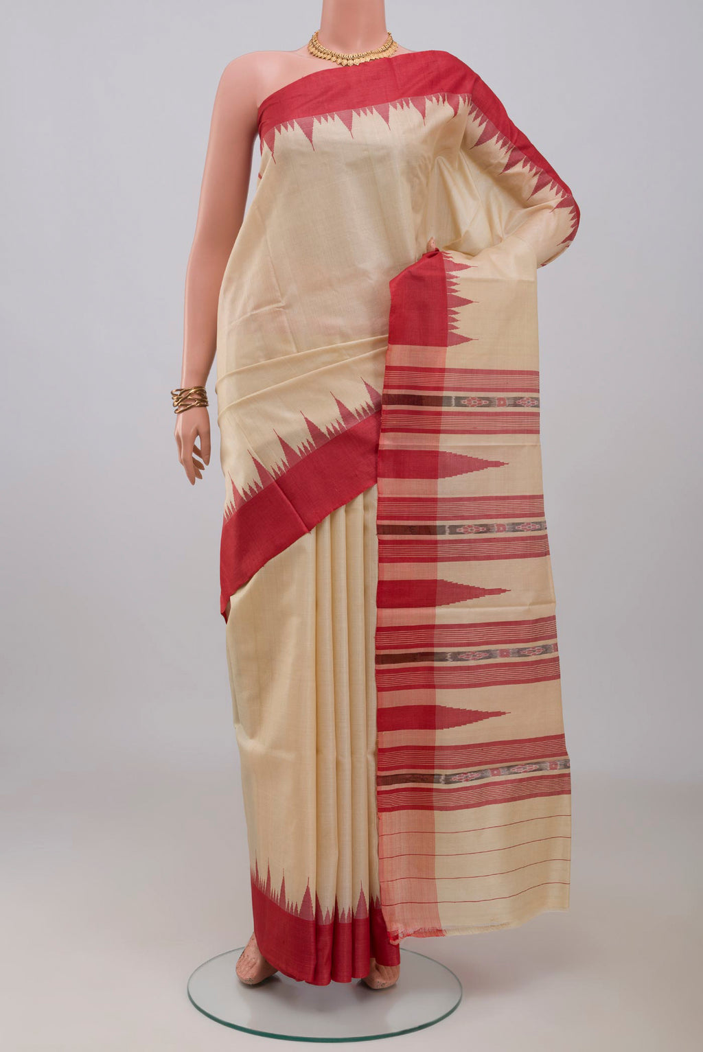 Cream Tussar Silk Saree with Plain Body and Temple Border.  displayed on a mannequin