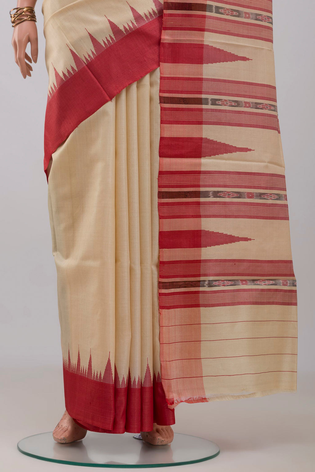 Pleats and pallu of Cream Tussar Silk Saree with Plain Body and Temple Border. 
