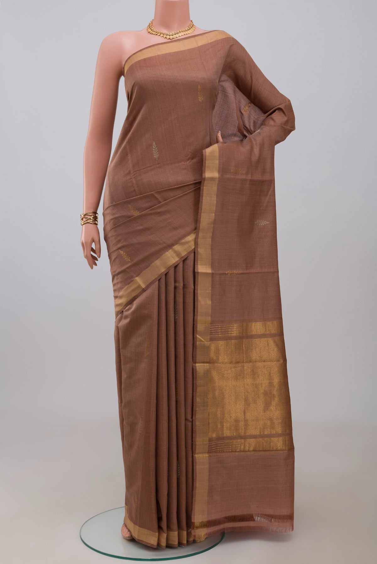 Brown Tussar Silk Saree with Zari Butta on the body and Zari Border.  displayed on a mannequin