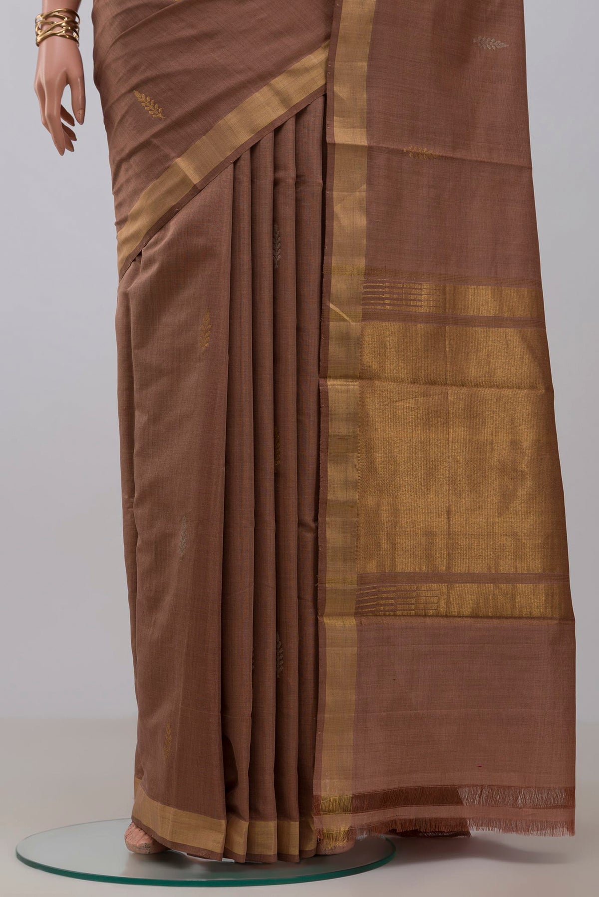 Pleats and pallu of Brown Tussar Silk Saree with Zari Butta on the body and Zari Border. 