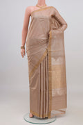 Beige Tussar Silk Saree with Zari Butta on the body and Thin Zari Line.  displayed on a mannequin
